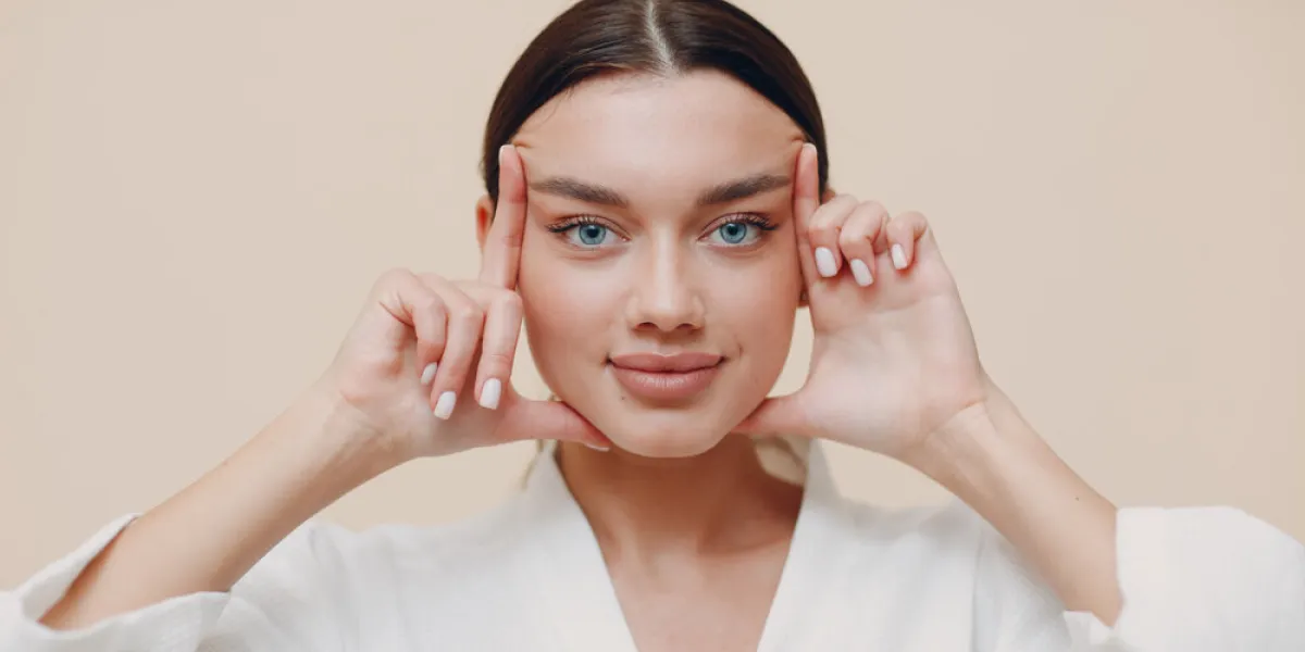 young woman doing face building facial gymnastics self massage and rejuvenating exercises