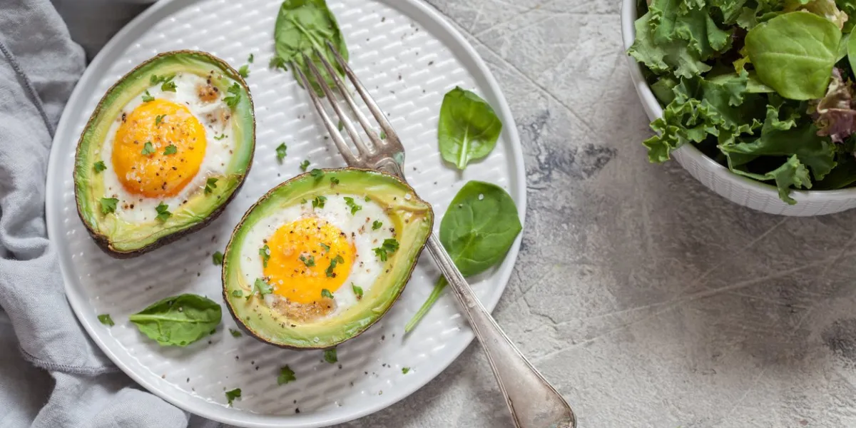 healthy breakfast avocado stuffed with eggs on the table