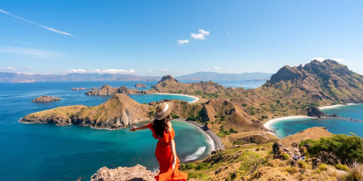 young female tourist enjoying the beautiful landscape at padar island in komodo national park, indonesia