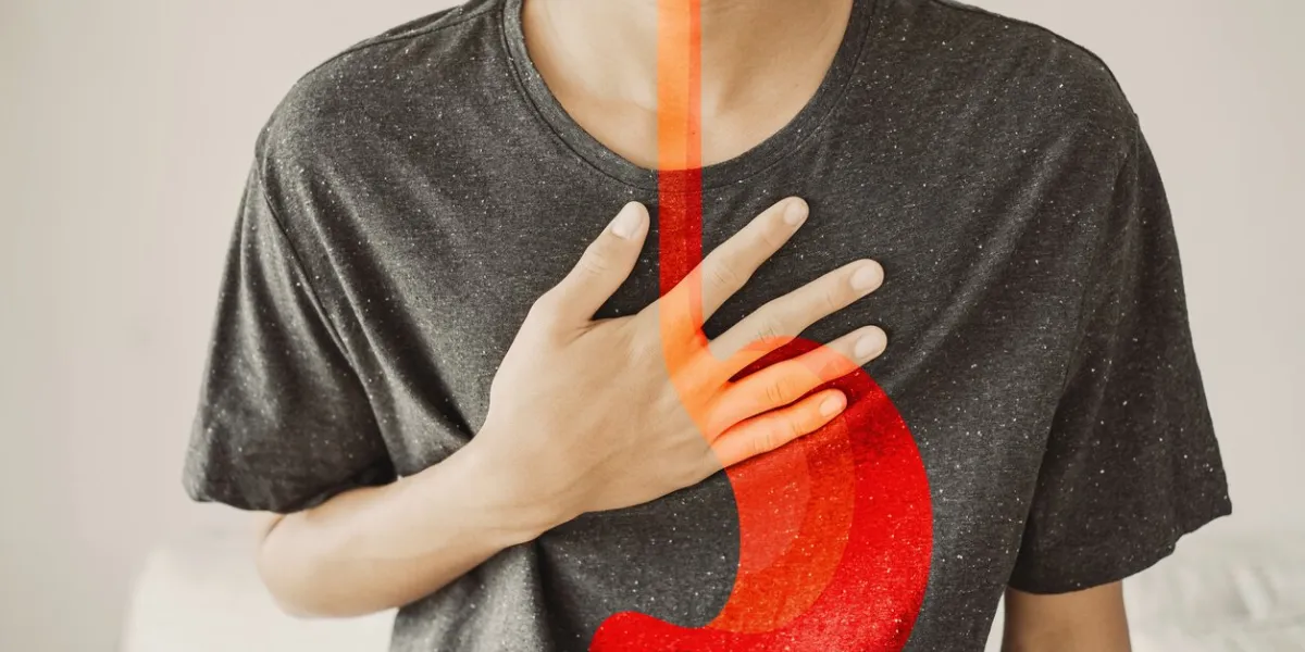 young man having heartburn, gastroesophageal reflux disease (gerd) or acid reflux symptom, health care concept