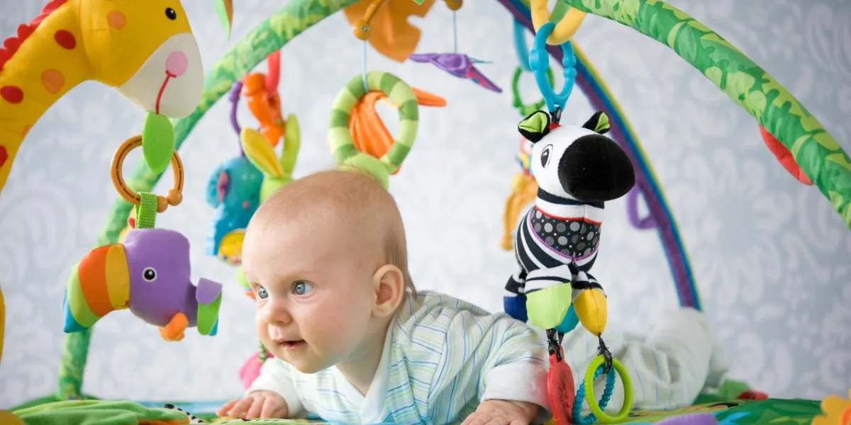 bébé jouant avec des jouets de bébé doux sur un tapis de jeu