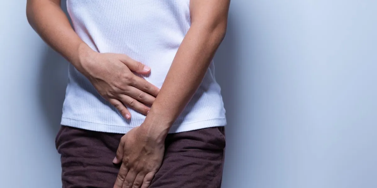 woman holding her crotch