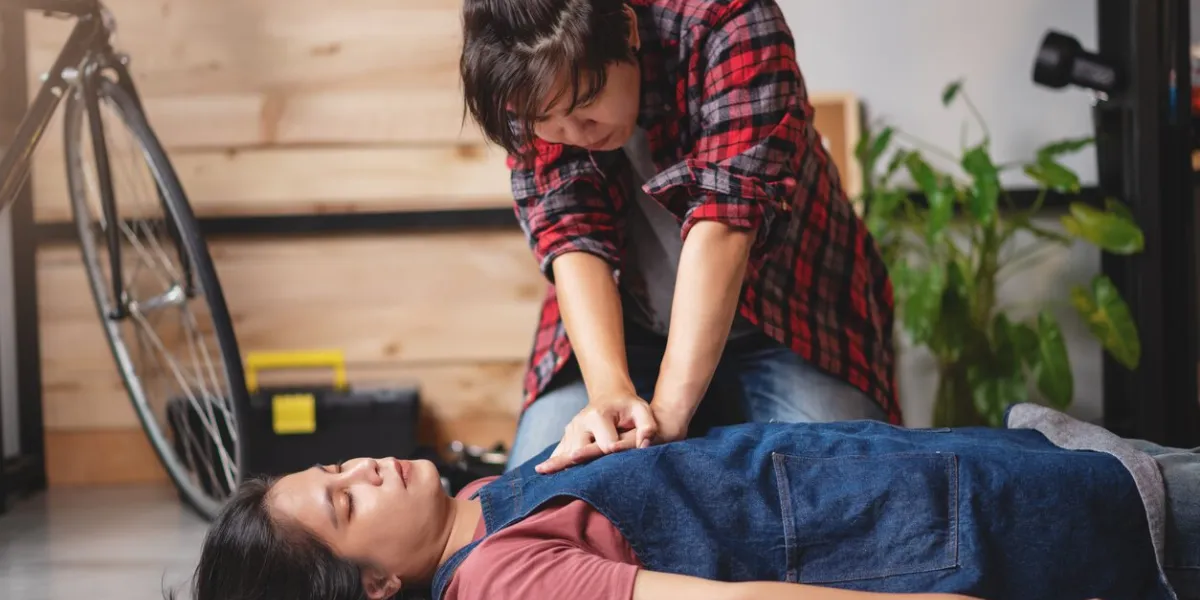 first aids emergency cpr on heart attack woman laying unconscious in home, one part of the process resuscitation - healthcare and insurance concept