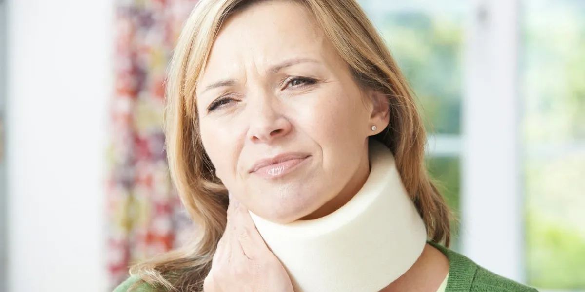femme portant un collier chirurgical dans la douleur