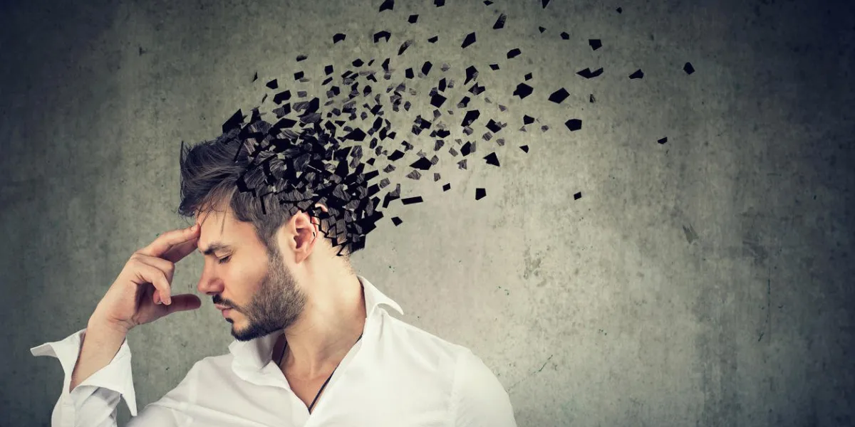 memory loss due to dementia or brain damage side profile of a man losing parts of head as symbol of decreased mind function