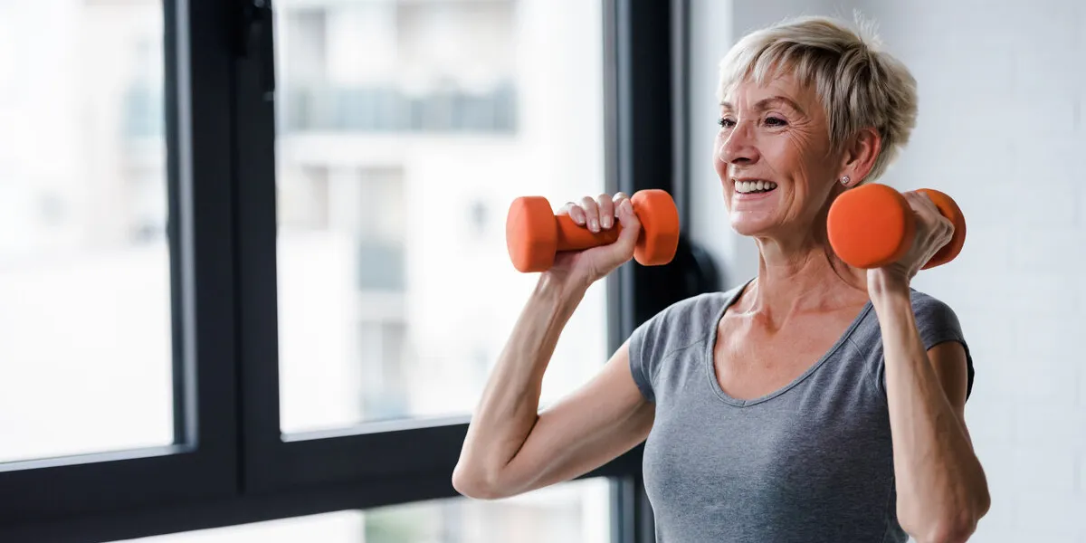 portrait of senior woman lifting dumbbells