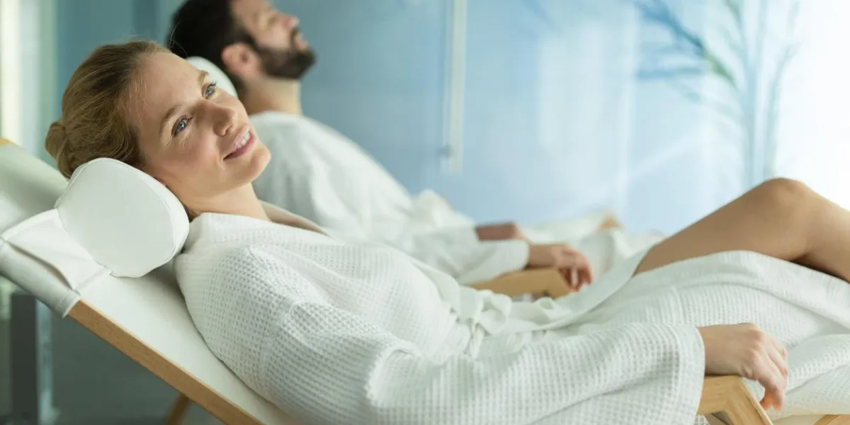 happy married couple relaxing at wellness spa resort