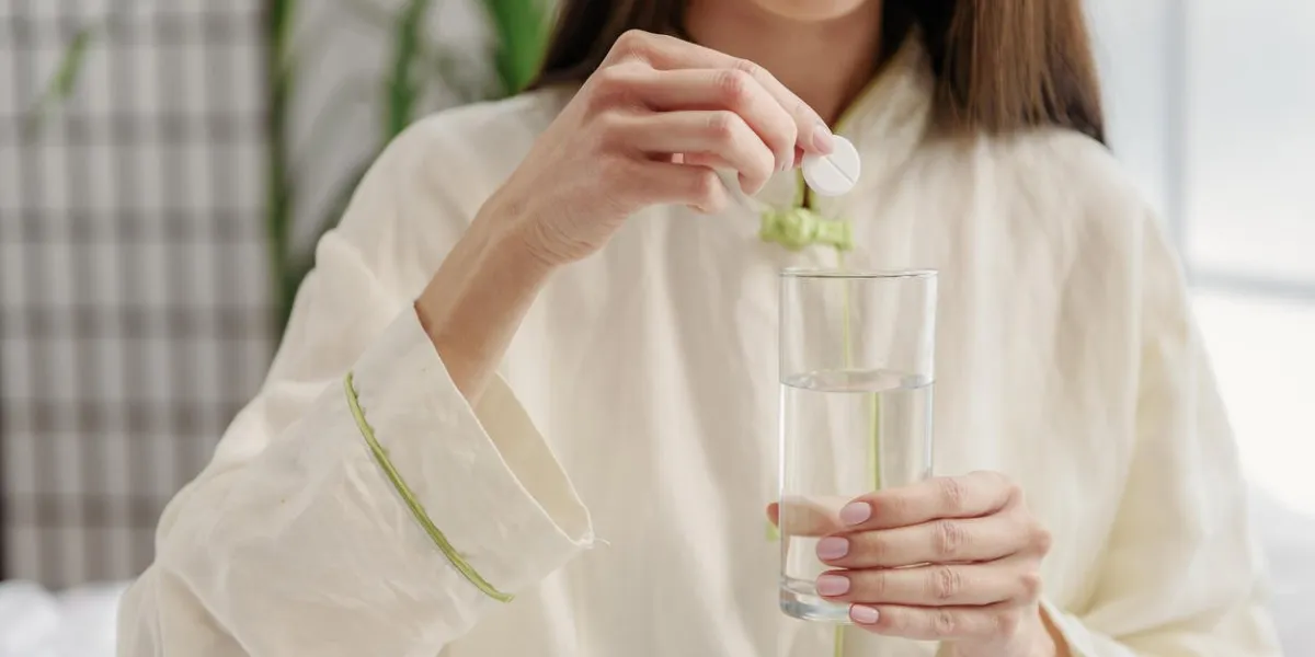 serene asian woman taking drug in liquid focus on medicine