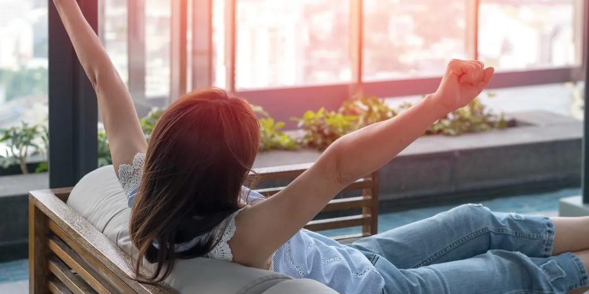 easy relax business woman lifestyle after work at hotel sitting hands behind head for happy businesswomen people simplify your life week international happiness day