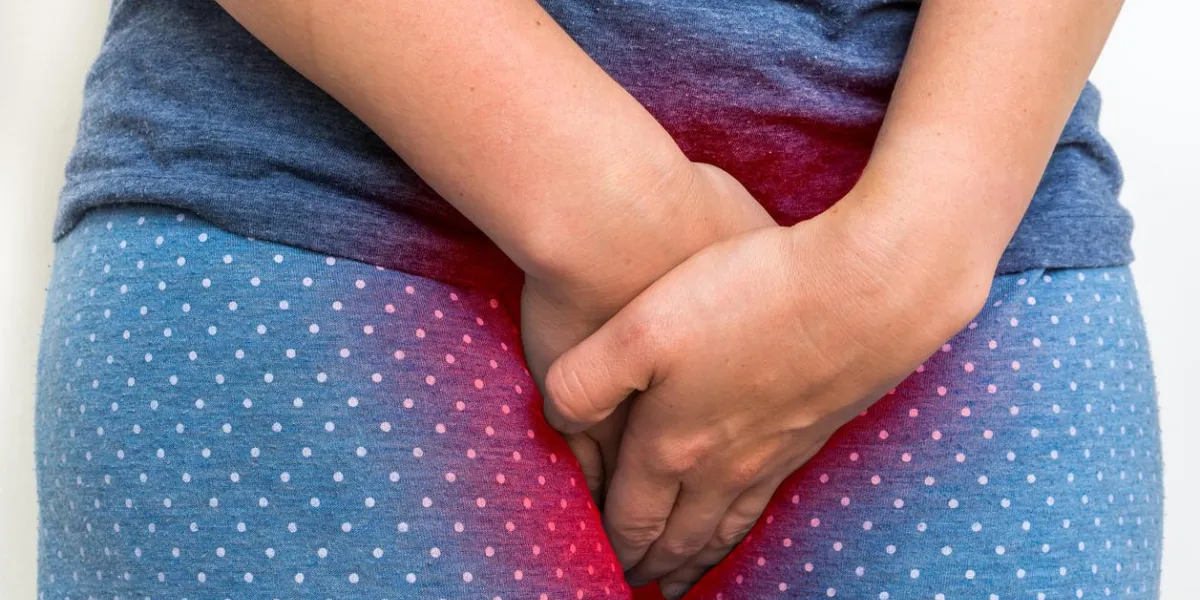 woman with incontinence problem is holding her crotch - incontinence concept