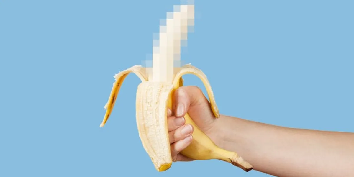 hidden censored banana in hand on a blue background horny (aroused) penis, male erection and sexual education funny pornography
