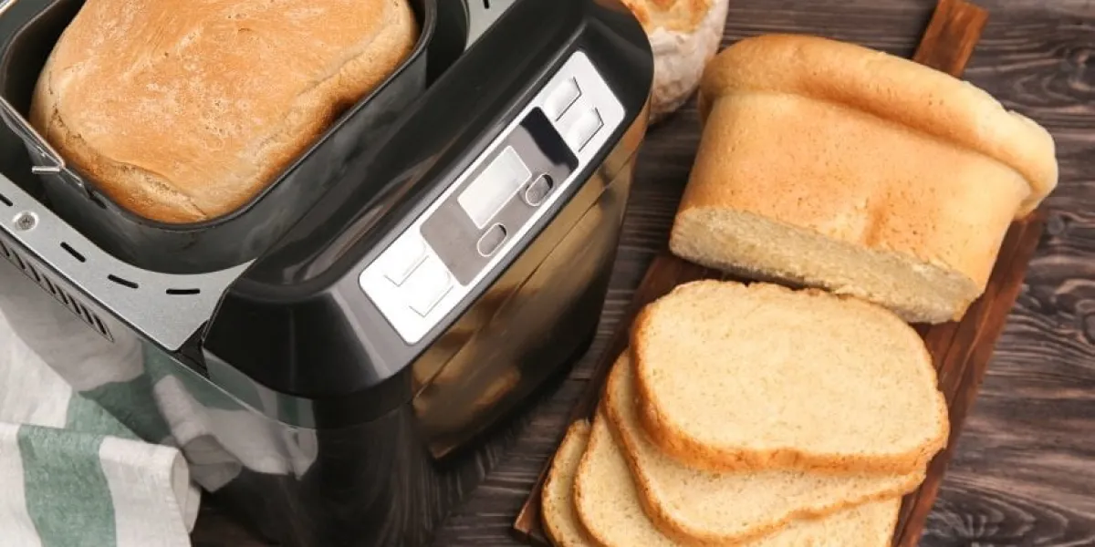 loaf baked in bread machine on wooden table