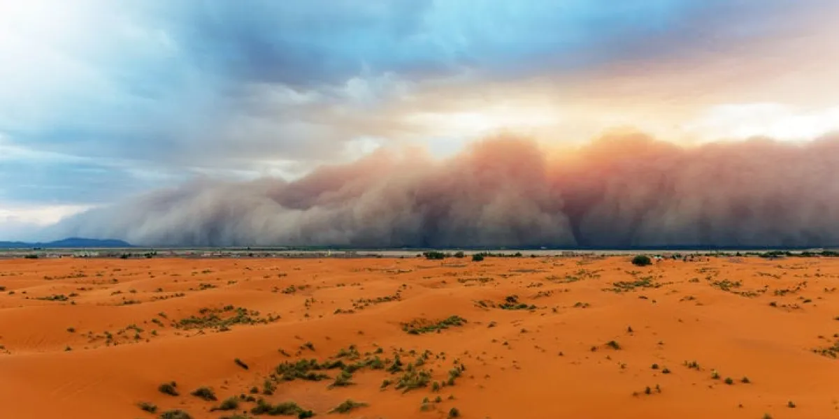 sandstorm comming fast towards merzouga in erg chebbi desert, morocco, africa thin green line is the settlementnikon d3x