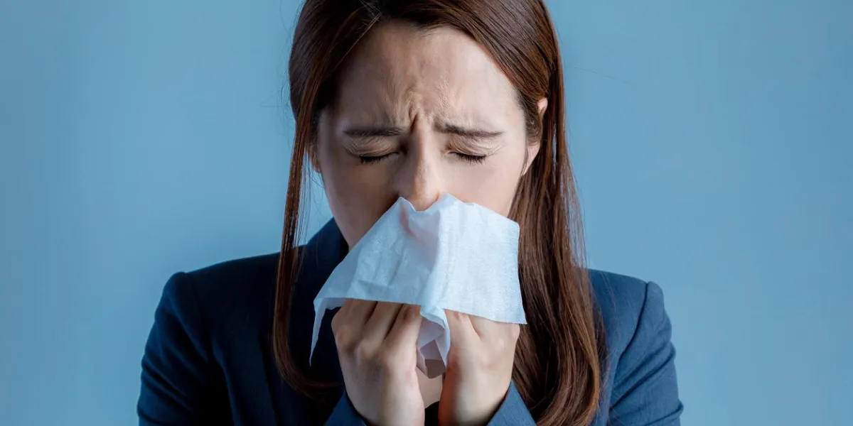 young woman blowing her nose allergic rhinitis hay fever