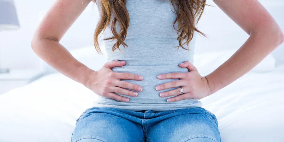 brunette suffering from stomach pain