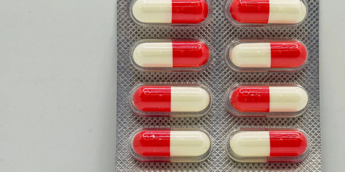 red and white pills isolated on white drug medical treatment