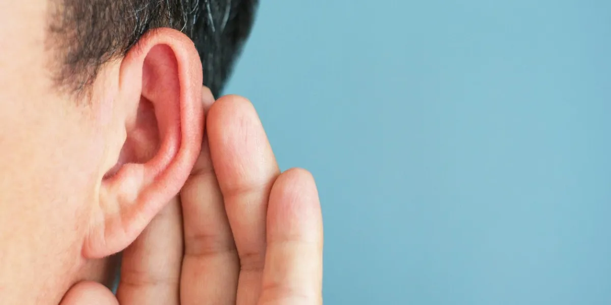 the man listens attentively with her palm to her ear, the news concept