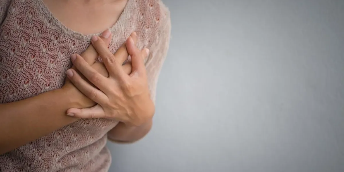 woman having a pain in the heart attact medical and health care concept