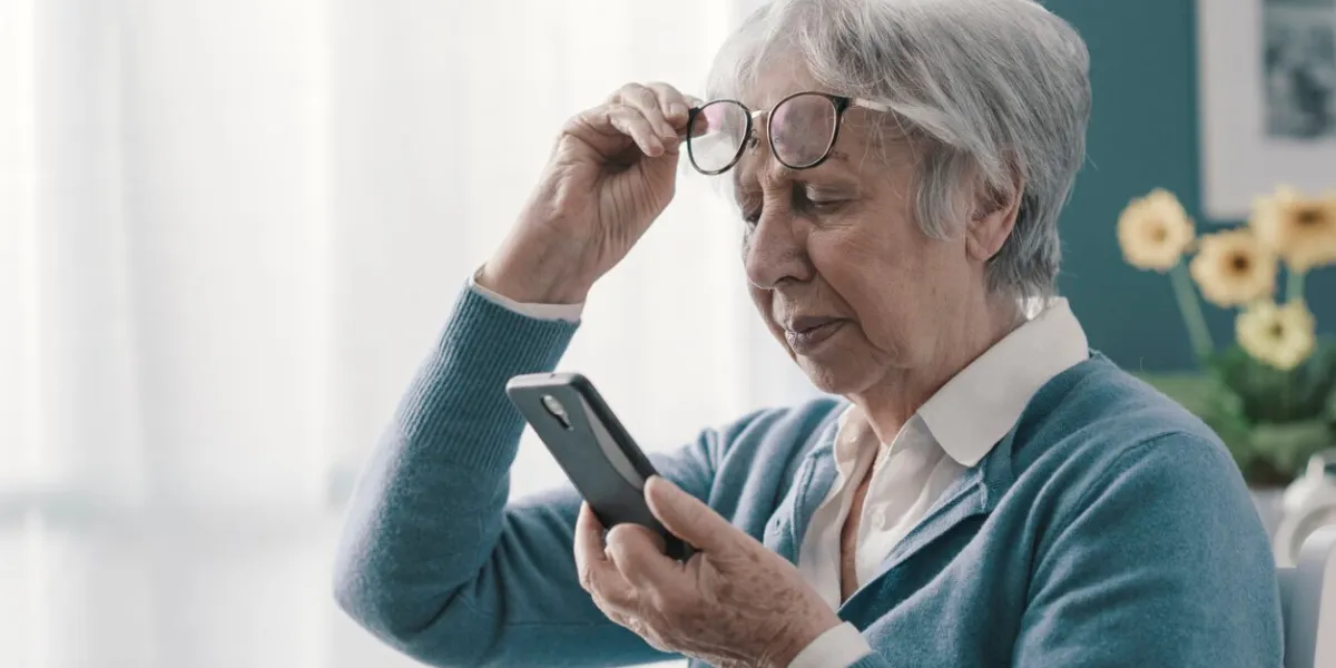 senior woman having vision problems, she can't read the messages on her smartphone