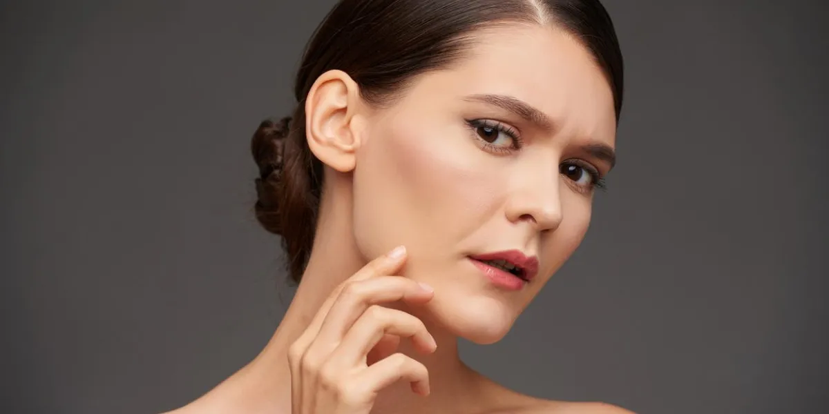 portrait of young woman unhappy with her skin condition