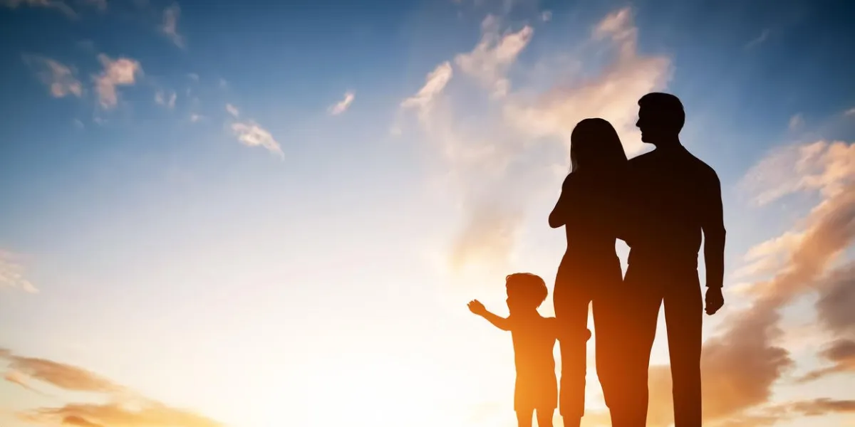 happy family together, parents with their little child at sunset boy reaching the sun