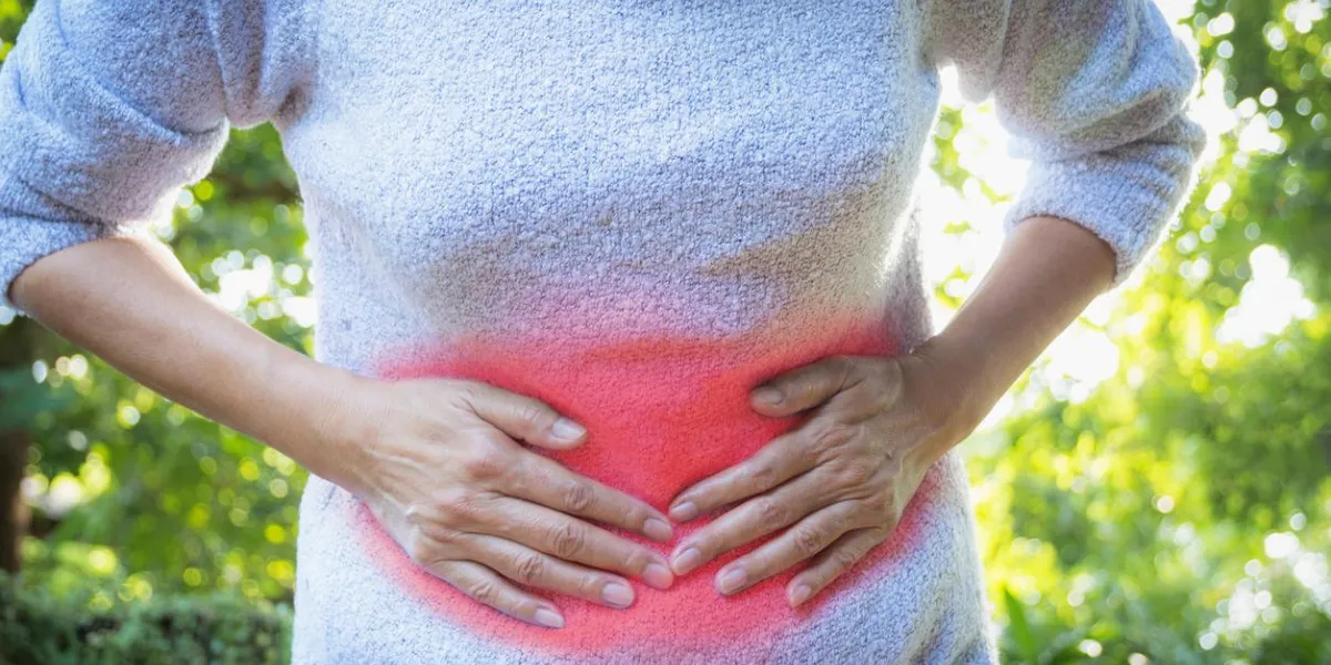 female suffering from stomachache pain,a woman stomachache at outdoor,healthy concept