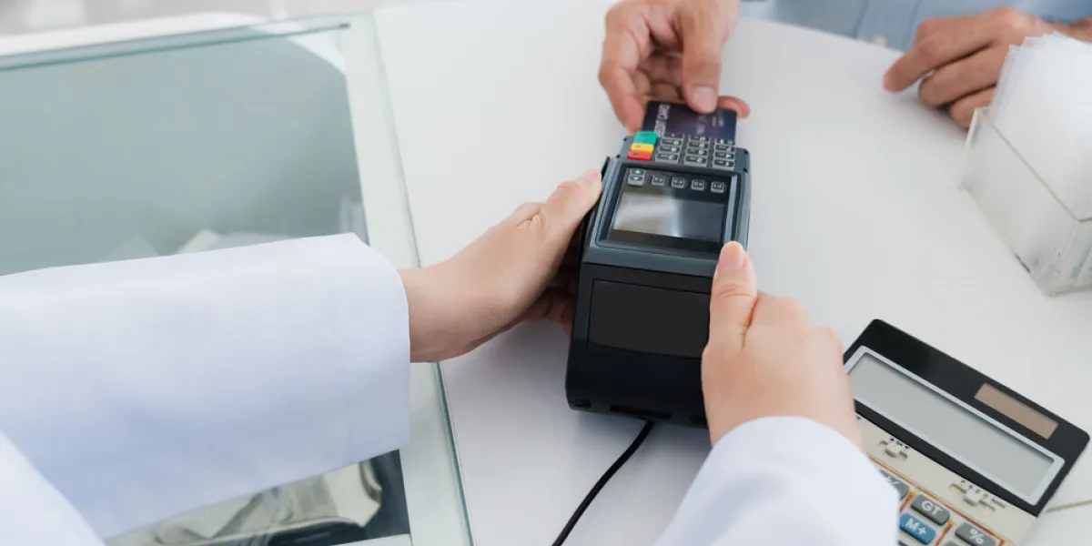 payment by credit card with payment terminal in qualified drugstore or hospital modern payment of electric money closeup customer purchase medication in pharmacy with credit card on pos