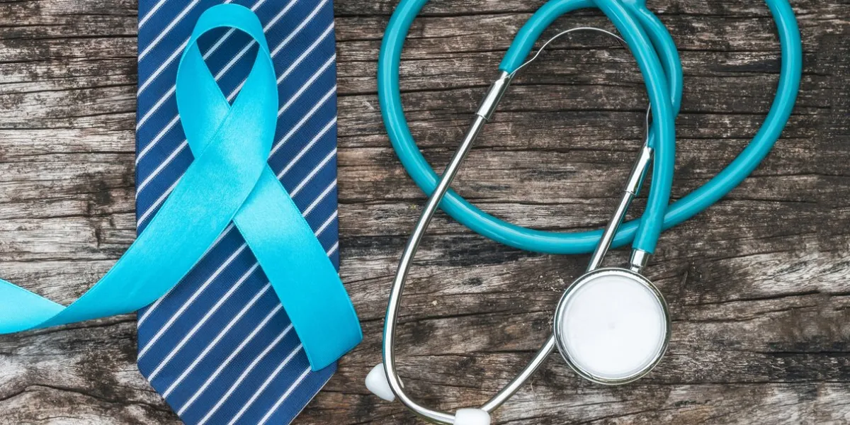 prostate cancer awareness concept with light blue ribbon on necktie and old aged wood for men's health care campaign in november and september month