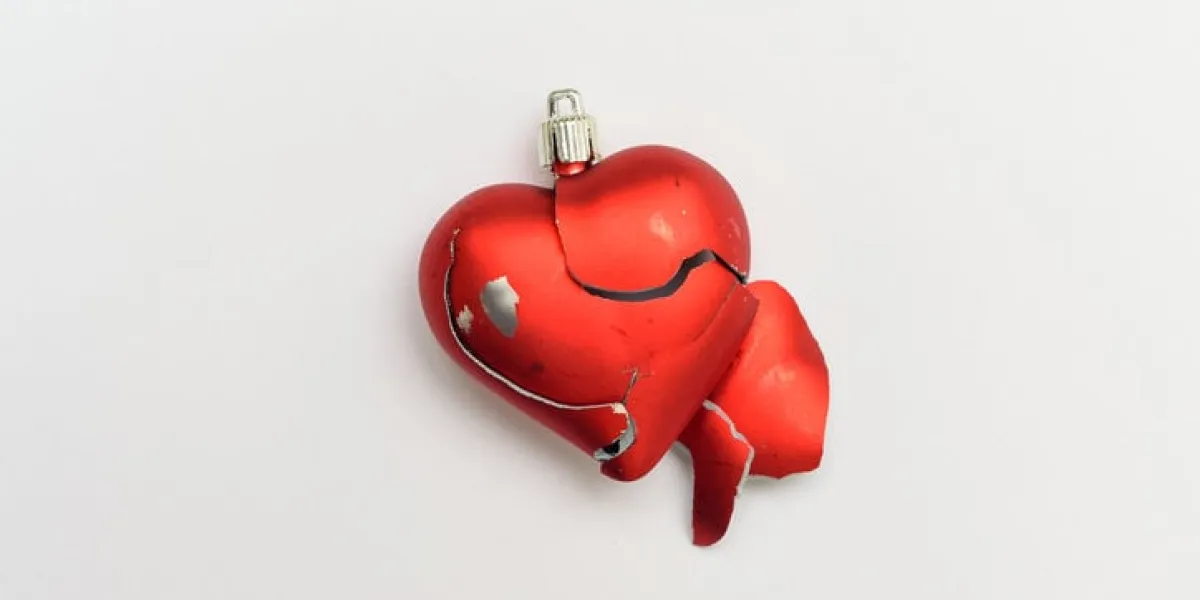 broken heart red heart isolated on white background as symbol of break up in relationship