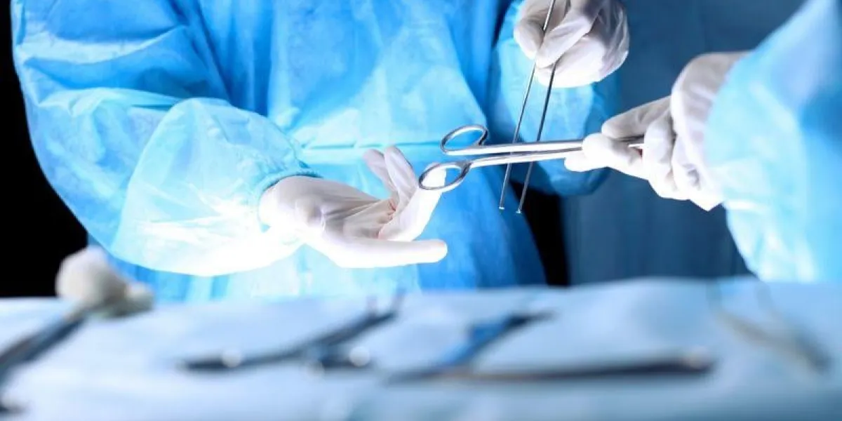 medical team performing operation group of surgeon is working in operating theatre toned in blue