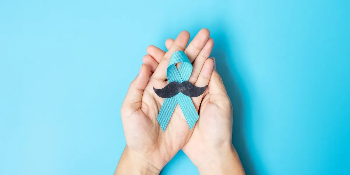 november prostate cancer awareness month, adult man holding light blue ribbon with mustache for supporting people living and illness healthcare, international men, father and world cancer day concept