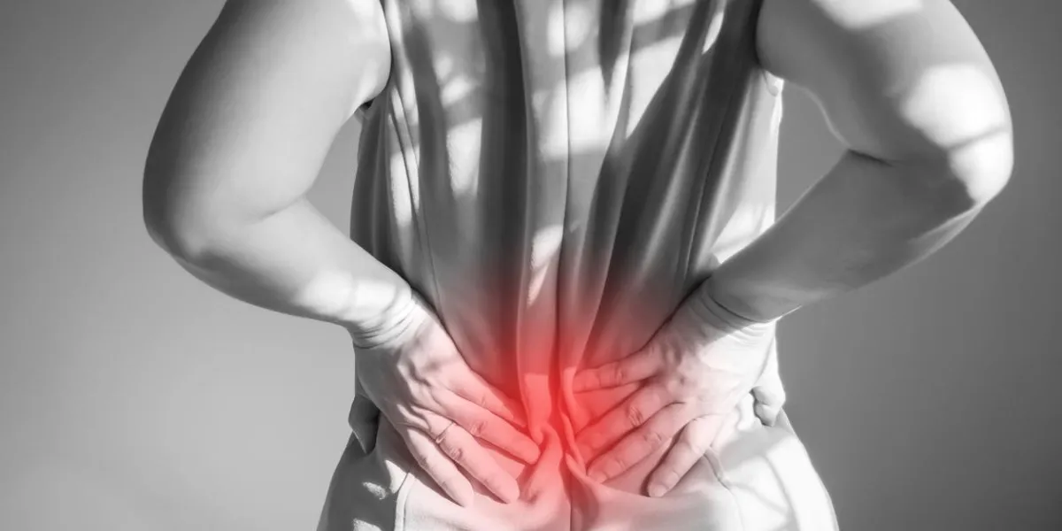 women are back pain used hand support at waist symptoms of office syndrome healthcare background black and white color theme with red color effect