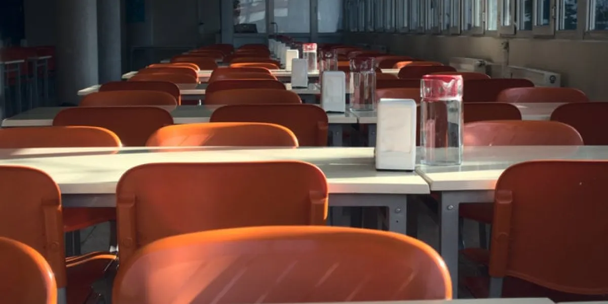 close up shot of empty red seats of a university cafeteria after the closing of schools