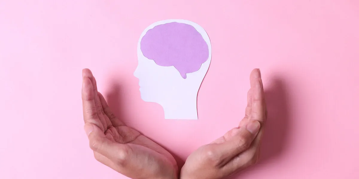 hands with brain paper cutout isolated on pink background world