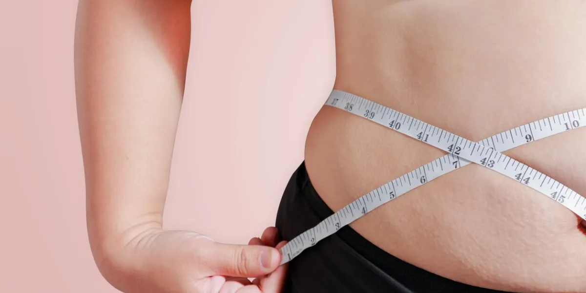 soft focus measure your body fat percentage with measuring tape for fat or obesity background