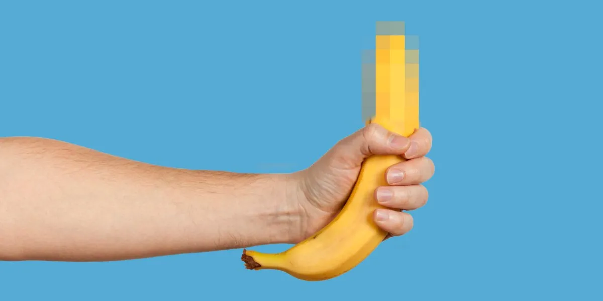 banana as a symbol of male penis in hand on a yellow background hidden by censorship sexual masturbation and orgasm, impotence problem self-pleasure concept