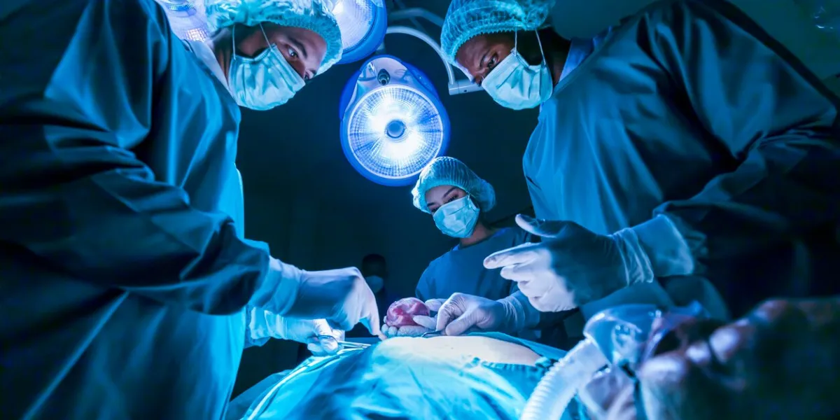 team of surgeon doctors are performing heart surgery operation for patient from organ donor to save more life in the emergency surgical room