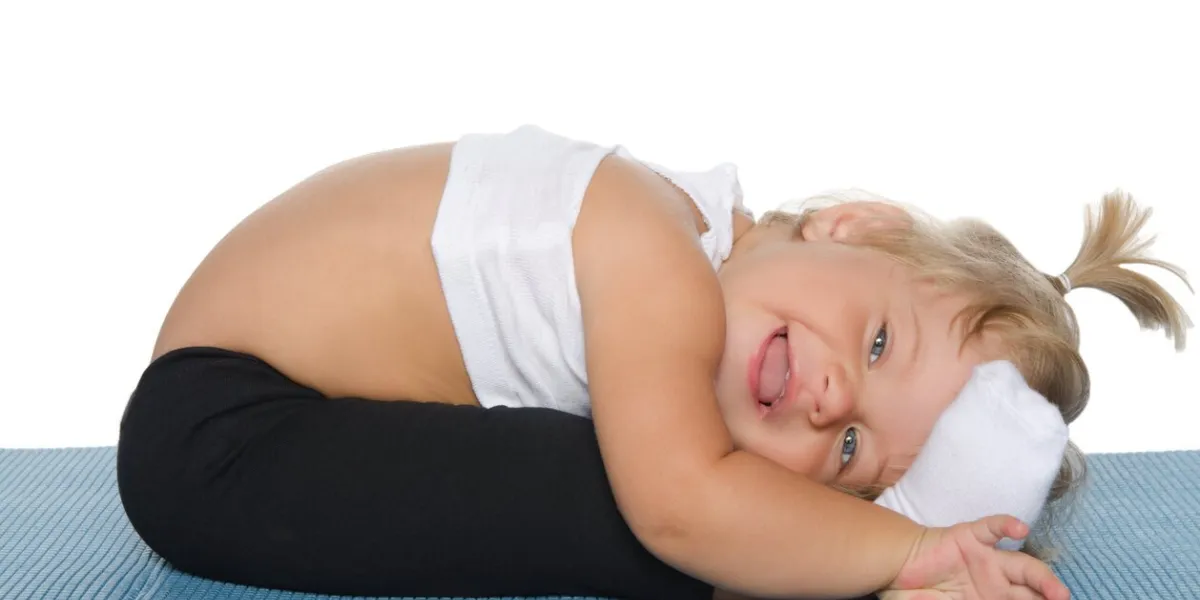 little girl doing gymnastics on blue mat