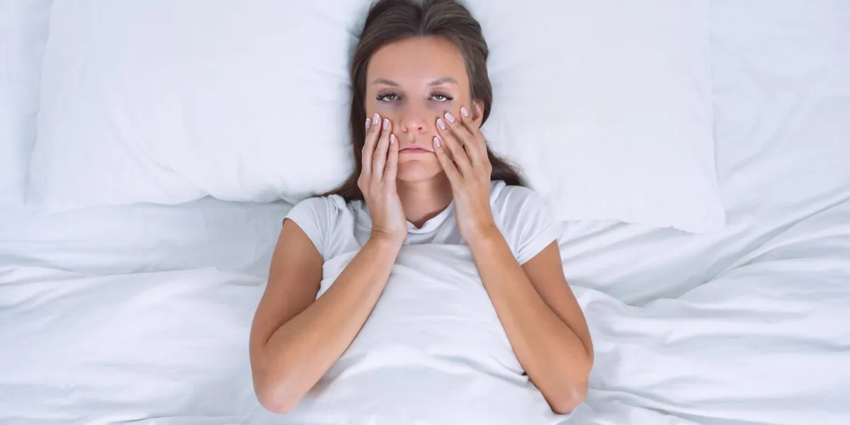 tired sleepy woman with chronic fatigue or depression lying in the bed bad morning high quality photo