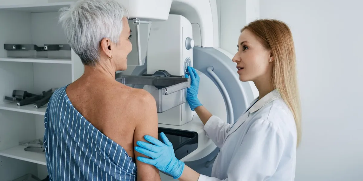 senior woman having mammography scan at hospital with medical technician mammography procedure, breast cancer prevention