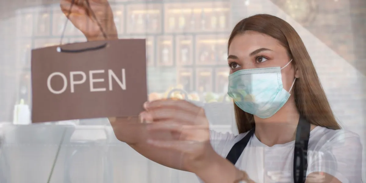 woman shop owner reopening the shop