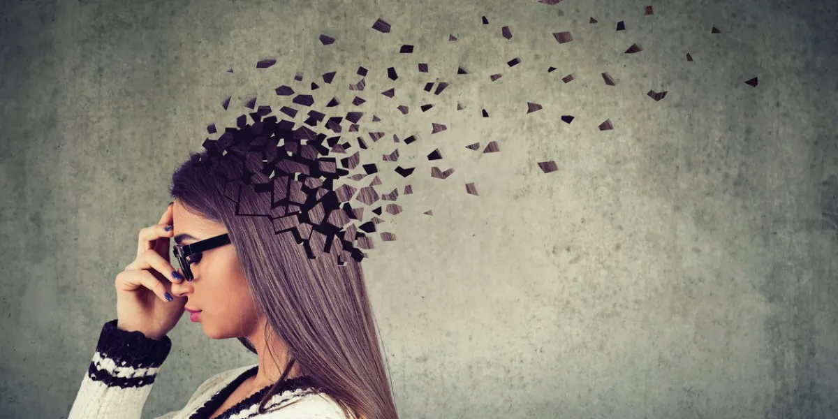 memory loss due to dementia or brain damage side profile of a woman losing parts of head as symbol of decreased mind function