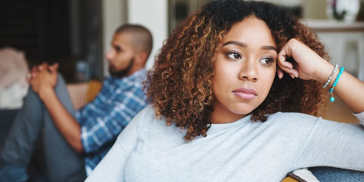 unhappy couple and sad woman upset after argument or conflict with her man on home sofa angry girlfriend or female thinking about disagreement or ignoring partner, tired of relationship problems