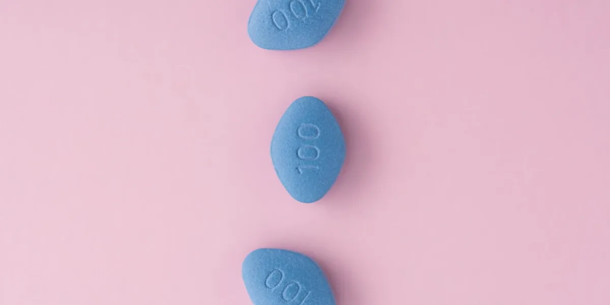 blue pills viagra on pink background top view medicine concept of medication for potency, erection, treatment of erectile dysfunction, pulmonary hypertension