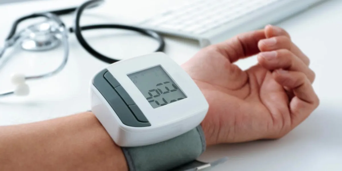 closeup of the arm of a caucaisan patient man whom is being measured his blood pressure with a sphygmomanometer at the doctors office