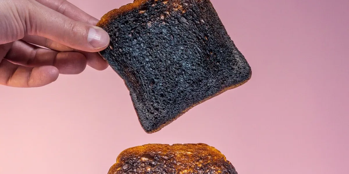 pieces of bread pop-up from breadtoaster burnt bread