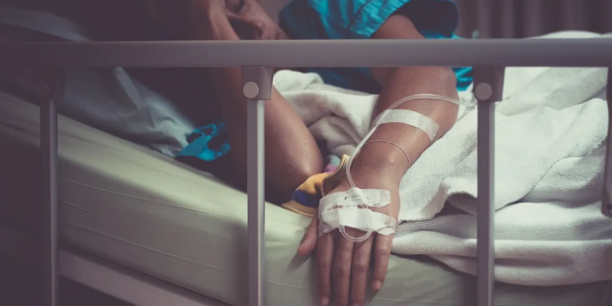 sick woman lying in bed in hospital
