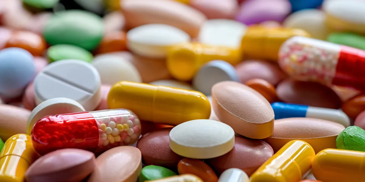 different colorful pills and drugs background medicinal tablets capsules pills selective focus