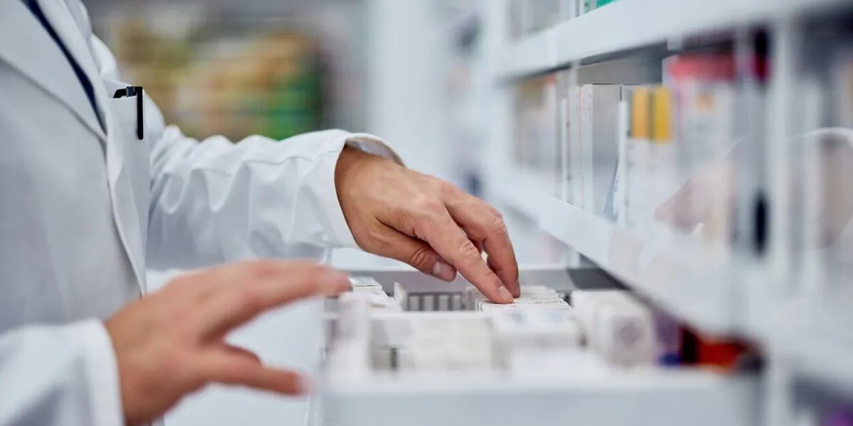 side view of a male hands, searching for something from the drawer, working as a pharmacist