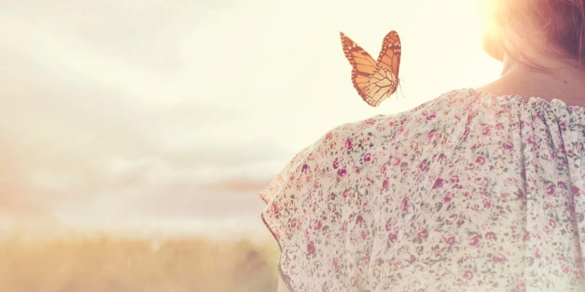 special moment of meeting between a butterfly and a girl in the middle of nature